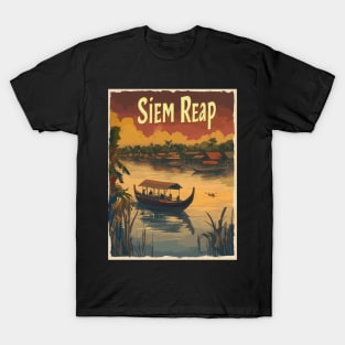 Witness the tranquility of Siem Reap as traditional boats glide through calm waters, reflecting the warm hues of a stunning sunset. Lush T-Shirt